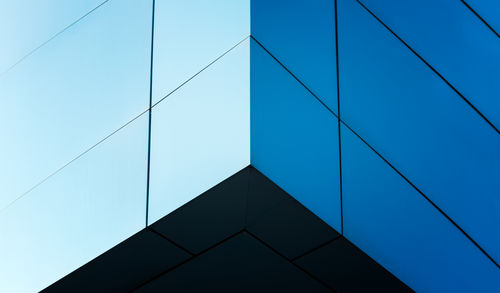 Low angle view of modern building against clear blue sky