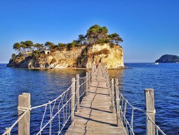 Scenic view of sea against clear blue sky