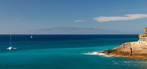 Scenic view of sea against blue sky