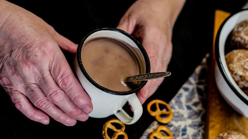 Cropped image of person holding coffee cup