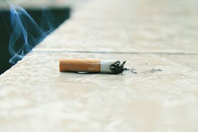 Close-up of cigarette on table