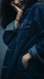 Midsection of woman in denim shirt