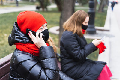 Woman with umbrella on mobile phone