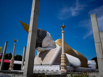 Low angle view of statue against blue sky