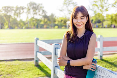 Portrait of smiling young woman standing outdoors