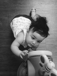 High angle view of baby girl playing with toy at home