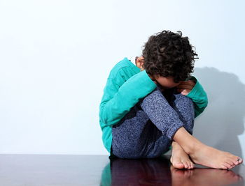 Boy in poverty also praying and crying for food  on white background stock photo