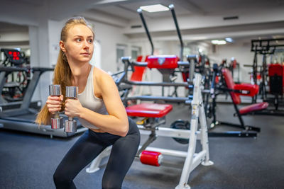 Young woman exercising in gym