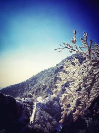 Low angle view of mountain against clear blue sky