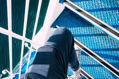 Low section of man walking on steps of ship