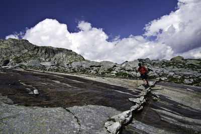 Hiker on mountain against sky