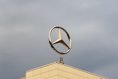 Low angle view of cross against sky