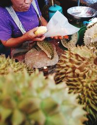 Close-up of man holding fish at market