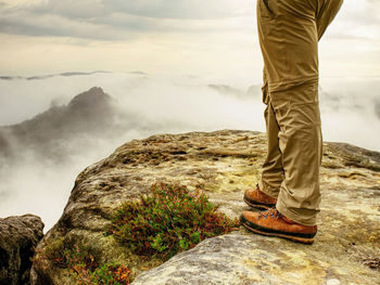 Person stand on the peak in rock empires park and watching over the misty and foggy morning valley