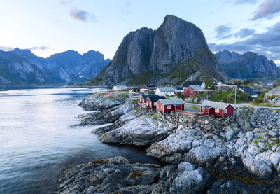 Scenic view of river and mountains against sky