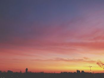 Silhouette buildings against sky during sunset