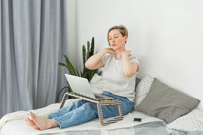 Young woman using laptop at home