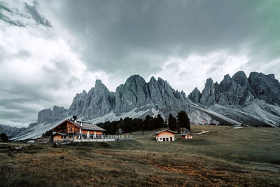 Scenic view of building and mountains against sky