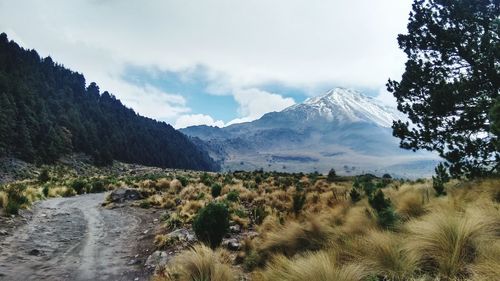 Scenic view of mountains against cloudy sky