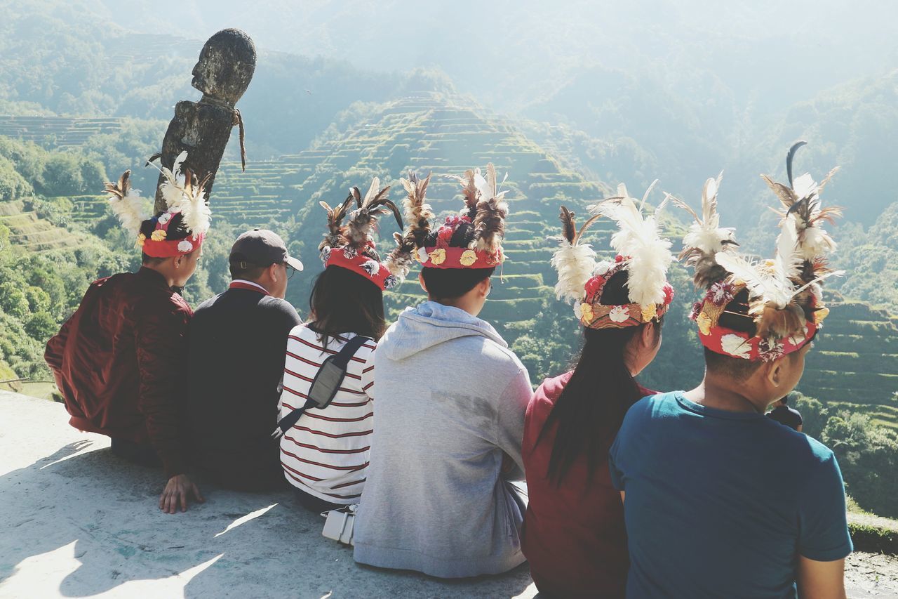 real people, group of people, men, large group of people, leisure activity, crowd, lifestyles, women, adult, nature, rear view, mountain, day, togetherness, traditional clothing, outdoors, enjoyment, watching