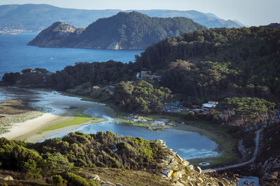 Scenic view of sea and mountains against sky