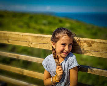 Portrait of girl smiling on railing