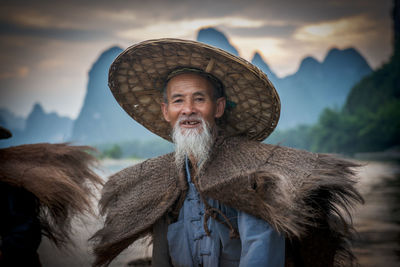 Portrait of man standing against sky