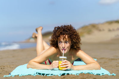 Portrait of woman sitting at beach