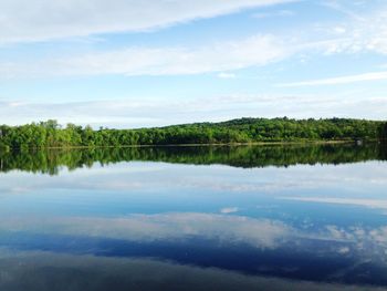 Scenic view of lake and trees against sky