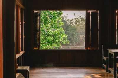 Trees seen through window of house