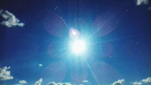 Low angle view of star field against blue sky