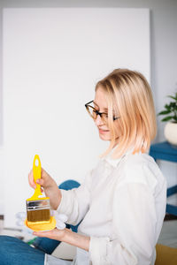 Young woman artist is painting at home in a creative studio setting.