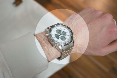 High angle view of man wearing wristwatch