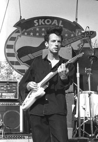 Portrait of a young man playing guitar