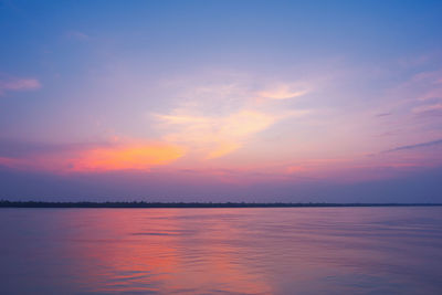 Scenic view of lake against romantic sky at sunset