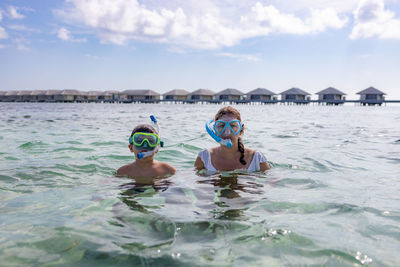 Mother and son snorkeling on the maldive islands