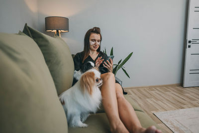 Portrait of woman with dog on floor