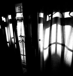 Close-up of man standing against window