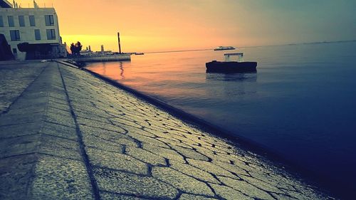 Pier on sea at sunset