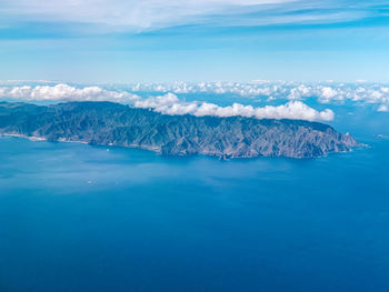 Scenic view of island and sea against sky