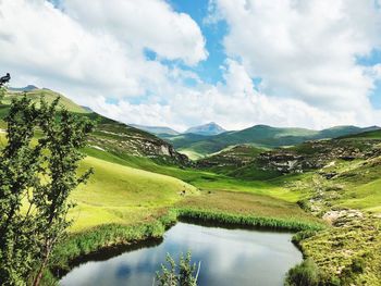 Scenic view of lake and mountains against sky