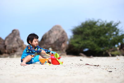 Girl plying on sand at beach