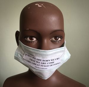 Close-up of mannequin with mask and quotes
