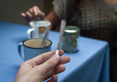 Close-up of hand holding candle