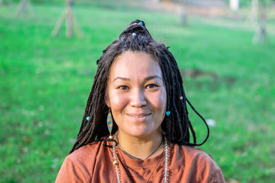 Portrait of beautiful european woman with long african braids and ethnic decorations. 