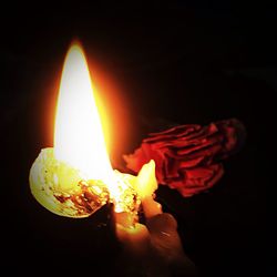 Close-up of lit candle in dark room