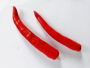 Close-up of red chili pepper against white background