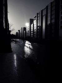 Street in city against clear sky at night