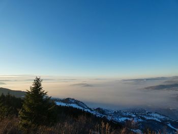 Scenic view of snowcapped mountains against clear sky