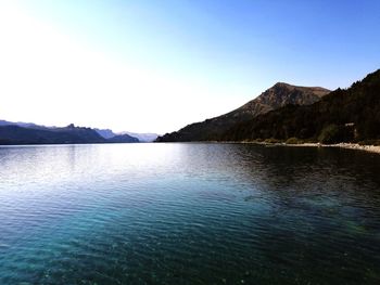 Scenic view of lake against clear blue sky